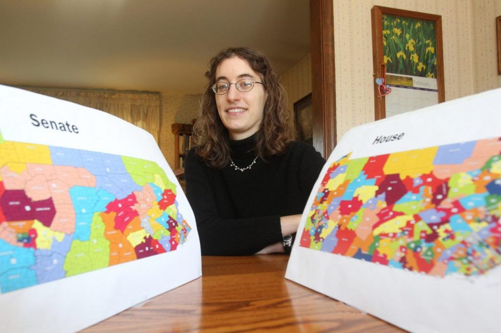 Amanda Holt holds up Pa. House and Senate maps