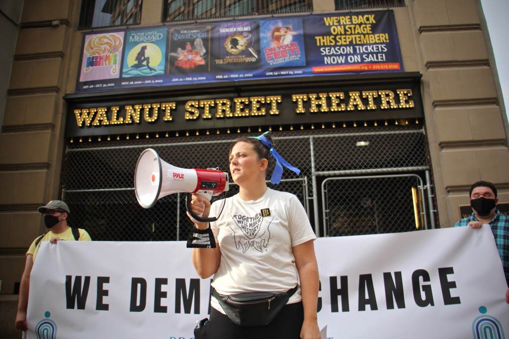 2020 06 18-e lee-jenna pinchbeck-philadelphia walnut street theater-protest march Organizer Jenna Pinchbeck reads the testimonies of those who suffered at the Walnut Street Theater to a crowd of about 80 protesters. (Emma Lee/WHYY)