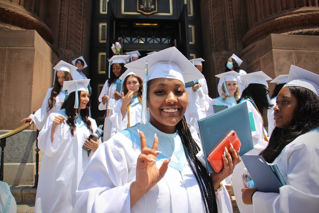 2021 06 07-e lee-philadelphia basilica of ss peter and paul-john w hallahan catholic girls high last class graduates smile Members of John W. Hallahan Catholic Girls’ High School Class of '21, the school's last class, leave the Basilica of Saints Peter and Paul after their graduation ceremony. (Emma Lee/WHYY)