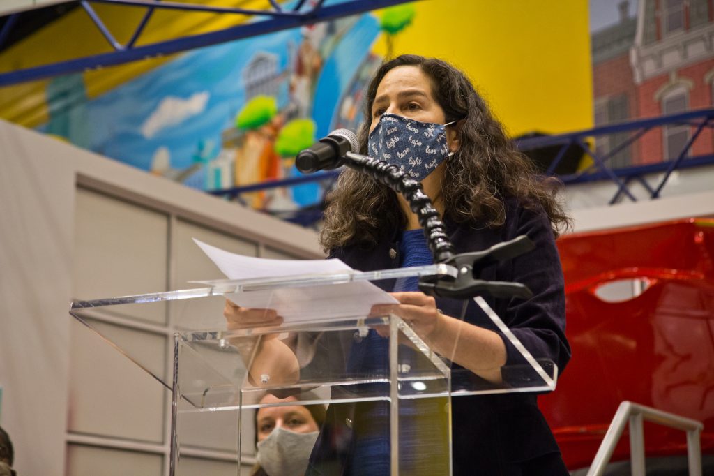 2021 06 08 k paynter covid child safety presser cheryl bettigole-2 Dr. Cheryl Bettigole speaks from a podium while wearing a face mask