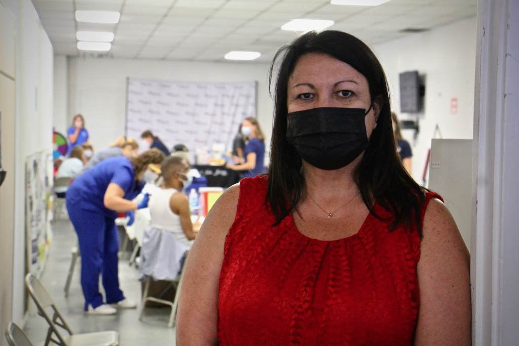 June Sieber poses while wearing a black face mask