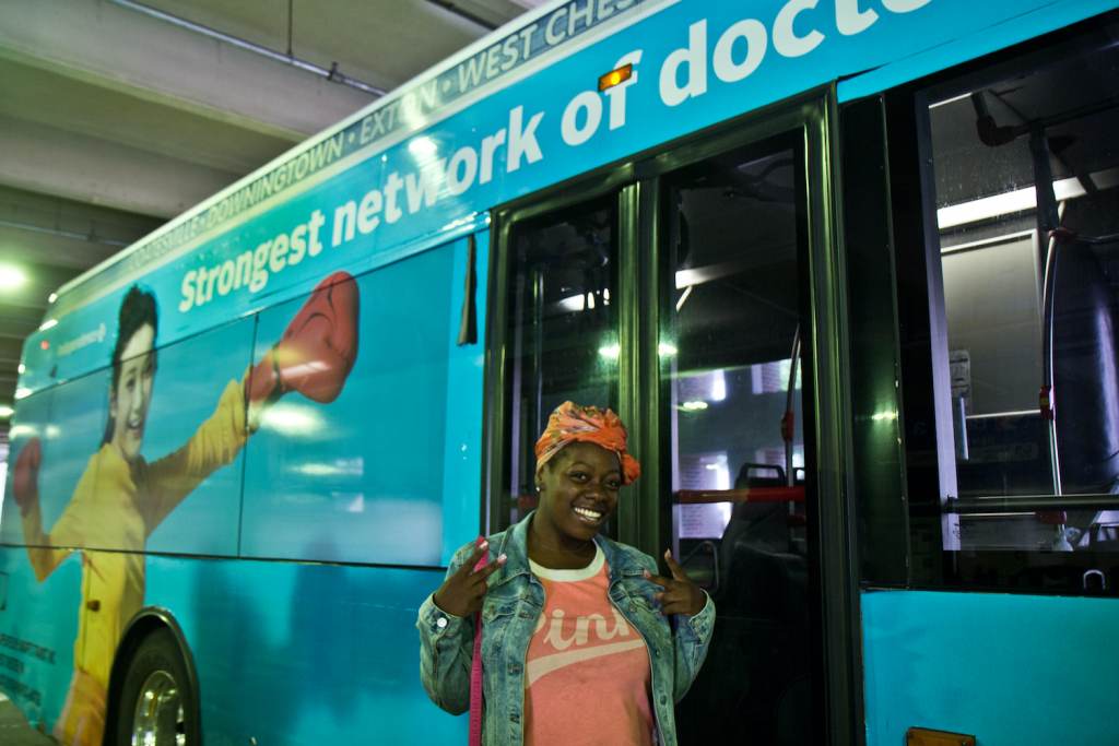 Shalika Shelton gestures outside of a Route A bus