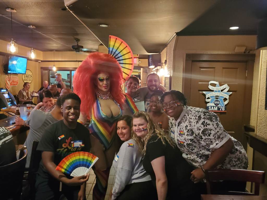 Pride Night at 2312 Garrett Bar in Upper Darby, 2021. It was the first Pride related event hosted by U.D.T.J. Bottom row from left to right: Elijah Neal, Ashely Rose, Valentina Kariouk, Dyamond Gibbs, BJ Bryant. 
Top row, left to right: Ophelia Hotass, Kyle McIntyre, name unknown. Minus Ophelia, the other people are the organizers of the Pride Festival and members of UDTJ. (Courtesy of UDTJ)