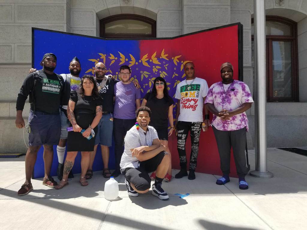 20210625_114643 Members of ad hoc group reimagining a new Pride in Philly. L - R: Maso Kibble, Diamond Anthony, Jessica Kallup, Manny Frank-Lampon, Rich Frank-Lampon, André Henson aka Alzei Barbei Mizrahi, Elicia Gonzales, Jamaal Henderson, and Abdul-Aliy Muhammad. (Peter Crimmins / WHYY)