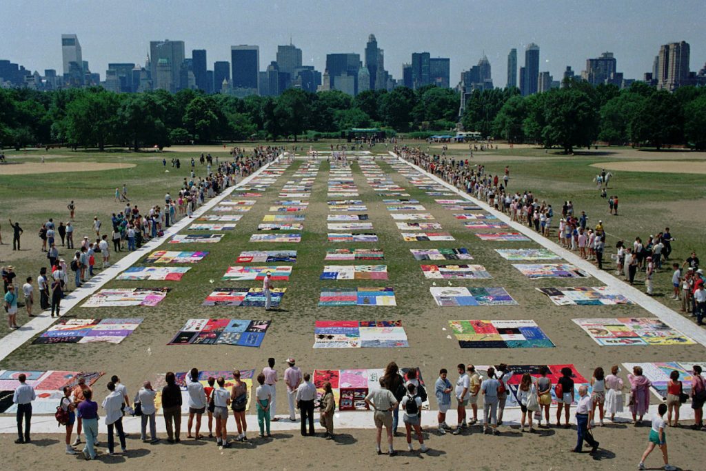 Virus Outbreak AIDS Crisis Remembered Onlookers watch as almost 1,500 quilt panels bearing the names of New York area residents who have died of AIDS are unfolded on the Great Lawn