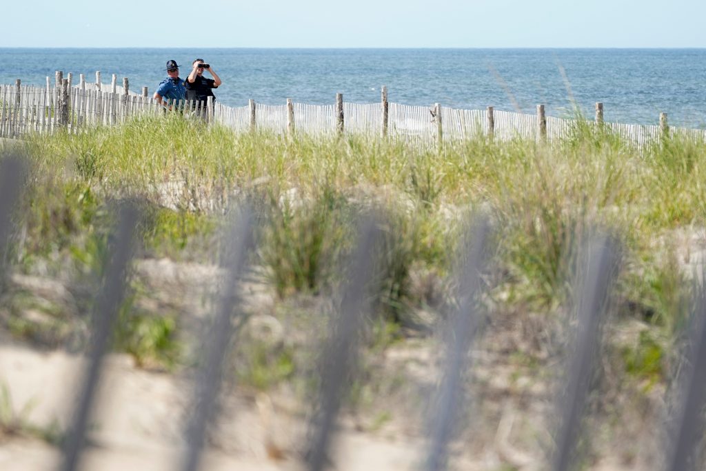 Biden Law enforcement officers guard the beach as they wait for Marine One, with President Joe Biden on board, to land at Rehoboth Beach, Del., Wednesday, June 2, 2021. Biden is spending a few days at his home in Rehoboth Beach to celebrate first lady Jill Biden's 70th birthday. (AP Photo/Susan Walsh)