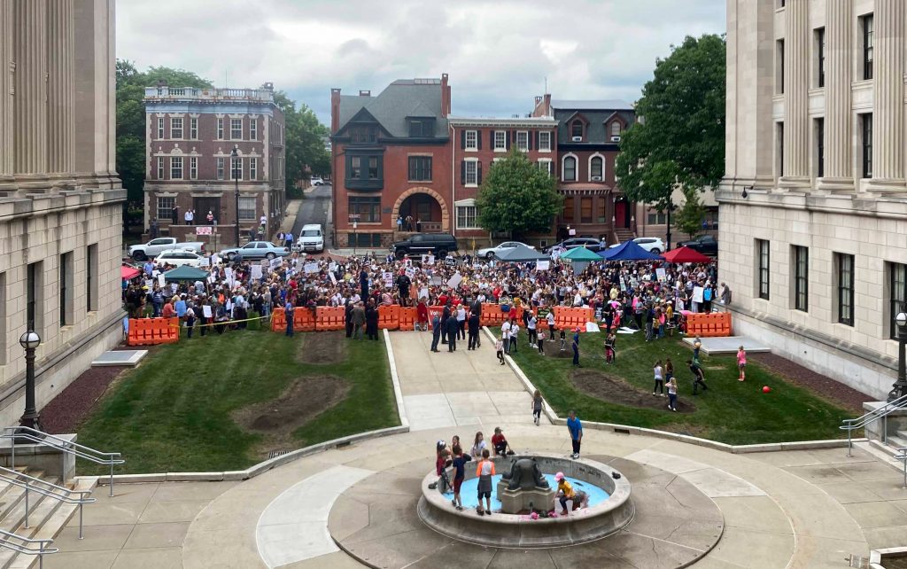 Virus Outbreak-New Jersey Rallygoers carry signs that say