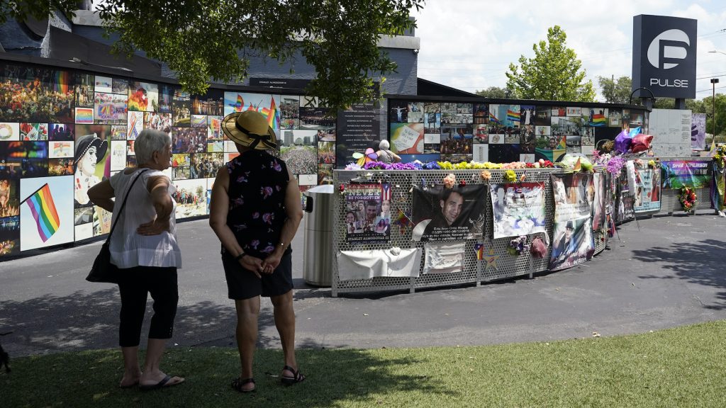 Nightclub Shooting Florida Visitors pay tribute to the display outside the Pulse nightclub memorial Friday, June 11, 2021, in Orlando, Fla. Saturday will mark the fifth anniversary of the mass shooting at the site. (AP Photo/John Raoux)