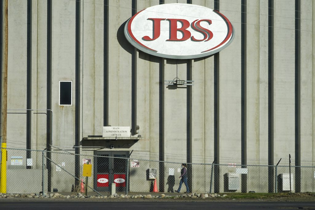 Australia JBS Cyberattack A worker walks into a JBS meat packing plant
