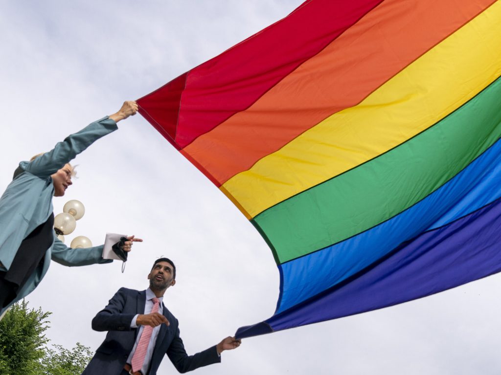Jennifer Granholm, Tarak Shah Energy Secretary Jennifer Granholm and Department of Energy Chief of Staff Tarak Shah help raise the Progress Pride Flag outside the DOE in Washington