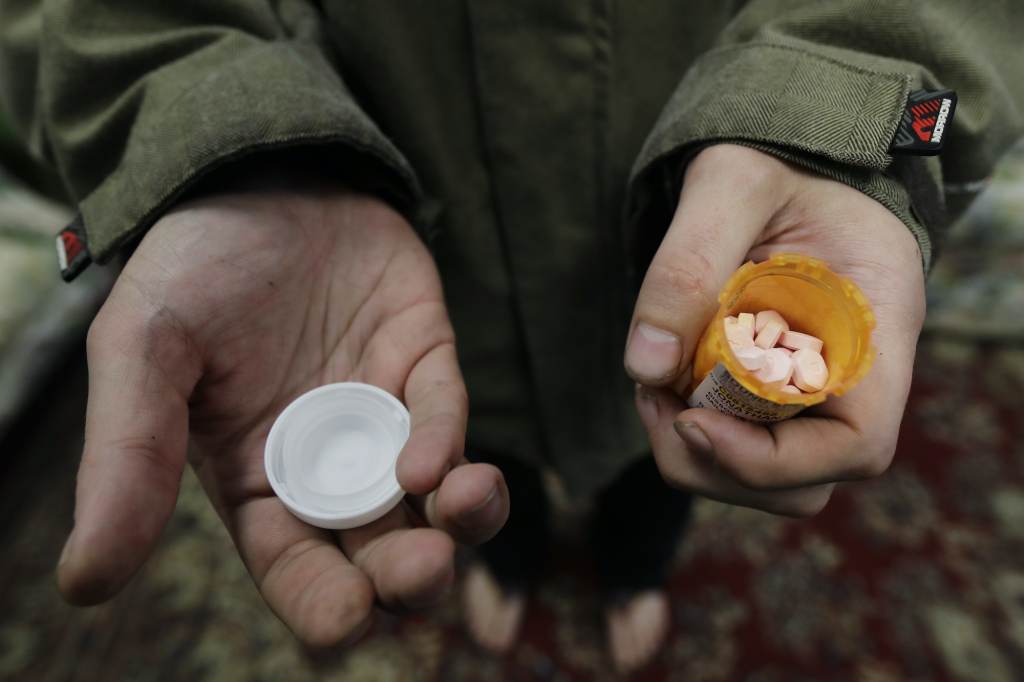 Opioid Crisis Medication First Jon Combes holds his bottle of buprenorphine