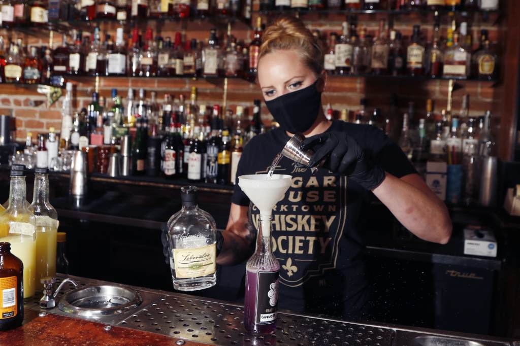 Shelby Minnix A bartender creates a cocktail in a to-go bottle