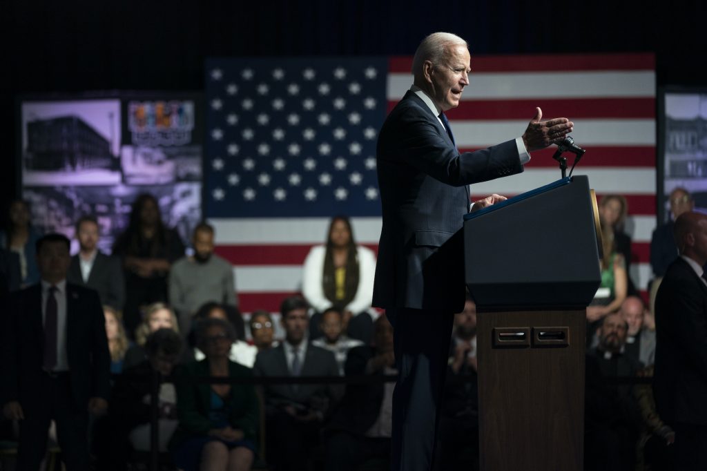 President Joe Biden gestures while speaking from behind a podium