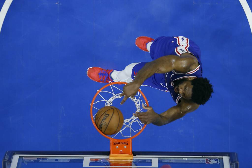 Hawks 76ers Basketball An overhead shot of Joel Embiid dunking a basketball during a playoff game