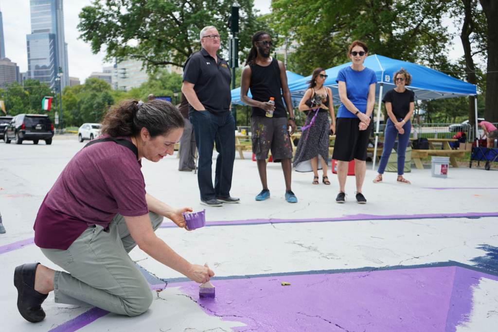 Acting Health Commissioner Dr. Cheryl Bettigole paints as Mayor Jim Kenney speaks with artist, Felix St. Fort, and Mural Arts executive director Jane Golden Acting Health Commissioner Dr. Cheryl Bettigole paints as Mayor Jim Kenney speaks with artist, Felix St. Fort, and Mural Arts executive director Jane Golden. (Kenny Cooper / WHYY)