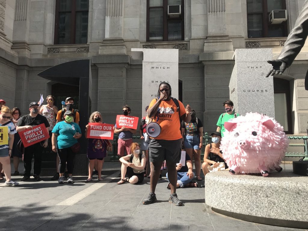 IMG_0678 Shane Riggins, of Philadelphia Socialist Alternative, leads a protest by the group Tax The Rich PHL against proposed business tax cuts in the Philadelphia 2022 municipal budget. (Laura Benshoff/WHYY)
