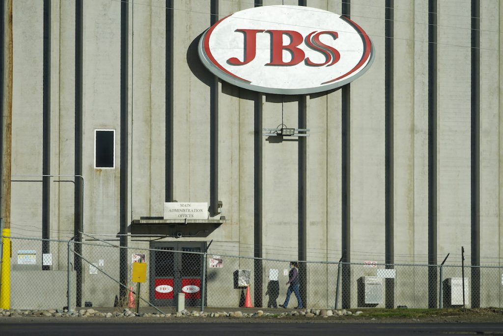 Australia JBS Cyberattack A worker heads into JBS meatpacking plant in Greeley, Colo. A ransomware attack on the world's largest meat company is disrupting production around the world just weeks after a similar incident shut down a U.S. oil pipeline. (AP Photo/David Zalubowski)