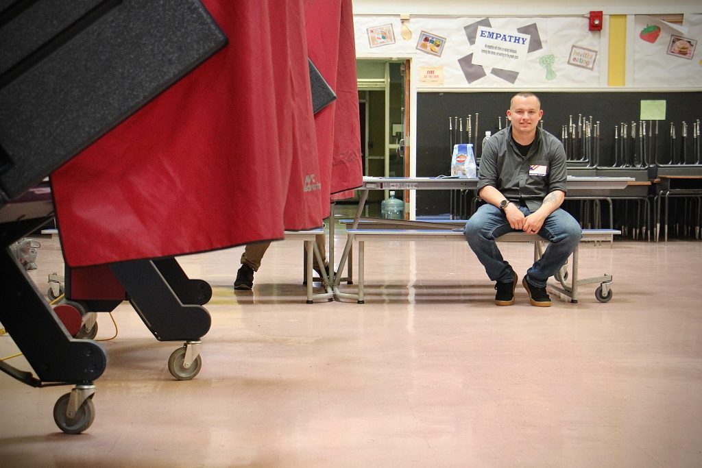 NJ_primary_election_polls_voting_EL_060821_01 National Guardsman Tim Rzemyk helps out at a polling place