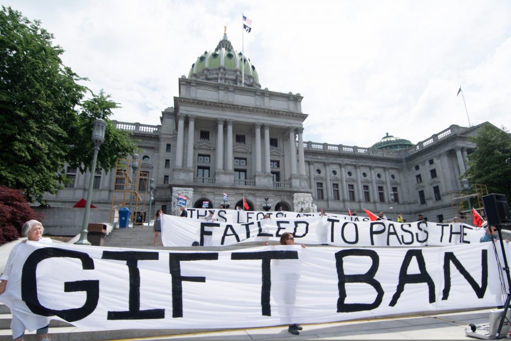 PA_protest_gift_ban_harrisburg_SPA_061021 Activists hold up a sign that says,