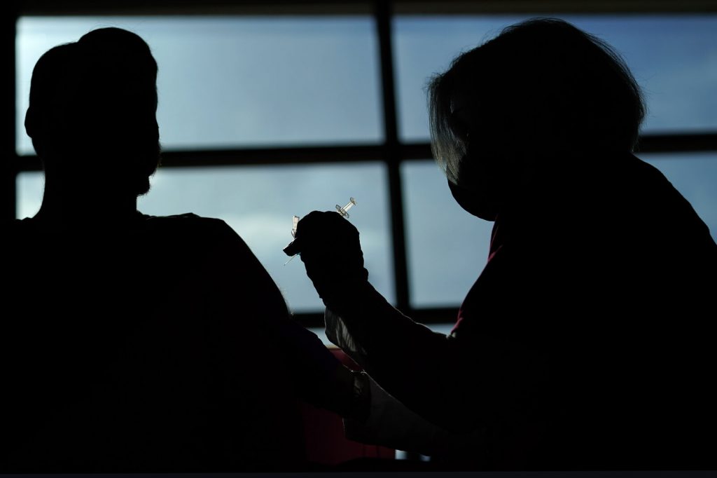 Devils Flyers Hockey A person receives a COVID-19 vaccination from a nurse practitioner