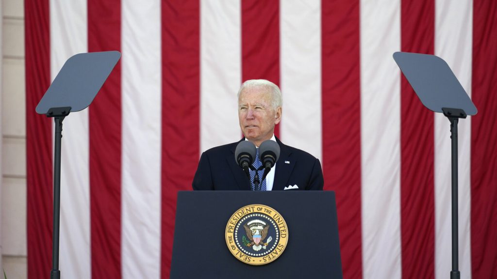 Joe Biden President Joe Biden speaks behind a podium, in front of an American flag