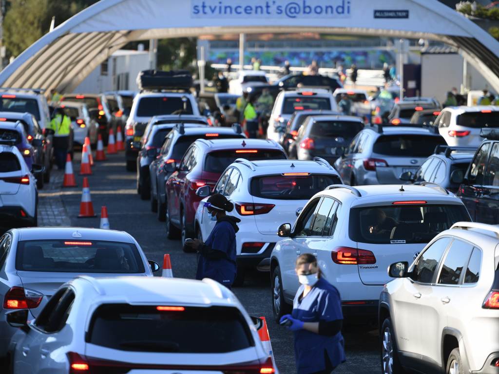 People line up in their cars to get tested for COVID-19 at a pop-up testing clinic at Bondi Beach in Sydney on Friday. Parts of Sydney will go into lockdown late Friday because of a growing coronavirus outbreak in Australia's largest city. (Dean Lewins/AP)