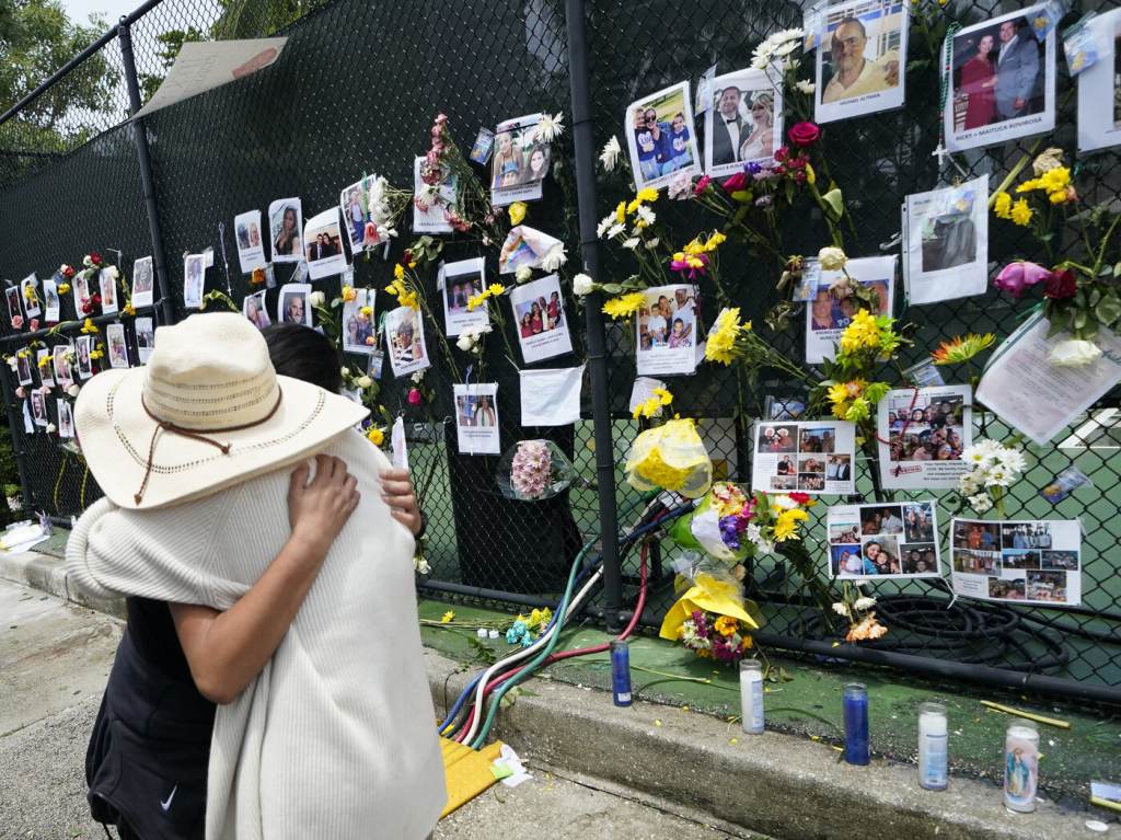 Building Collapse Miami People embrace at a make-shift memorial