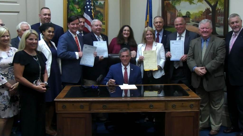 carney1 Delaware Gov. John Carney signs several budget bills surrounded by legislative leaders in his Dover office Wednesday afternoon. (courtesy Gov. Carney's office)