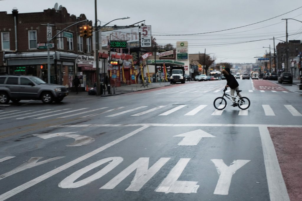 frisking-nyc_slide-1a86c3371241f342823d2a36ab5c2dedafe39e18-s1600-c85 A person rides a bike across a New York street