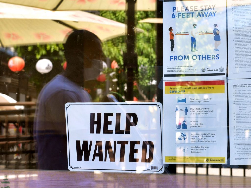A ‘Help Wanted’ sign is posted beside Coronavirus health safety guidelines at a restaurant in Los Angeles on May 28. Businesses are desperate for workers even as millions remain unemployed. Republican governors blame a major unemployment benefit passed during the pandemic, saying it’s dissuading people from rejoining the workforce. A 'Help Wanted' sign is posted beside coronavirus safety guidelines in front of a restaurant