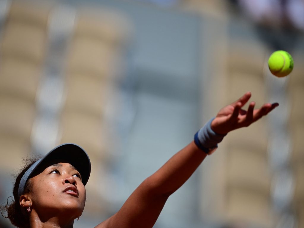 Japan’s Naomi Osaka eyes the ball as she serves during the first round of the French Open tennis tournament in Paris on Sunday. Japan's Naomi Osaka eyes the ball as she serves to Romania's Patricia Maria Tig