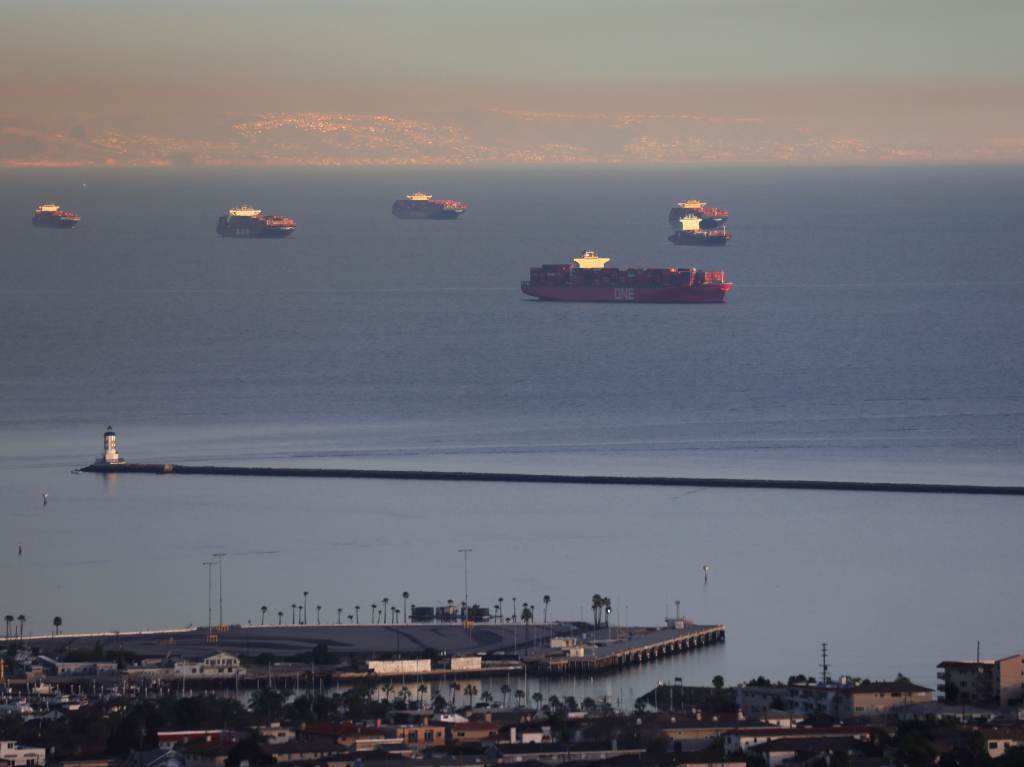 Container ships and tankers are anchored close to the ports of Los Angeles and Long Beach