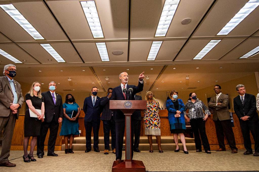 gov_tom_wolf_inky_063021 Gov. Tom Wolf speaks from a podium, flanked by other officials
