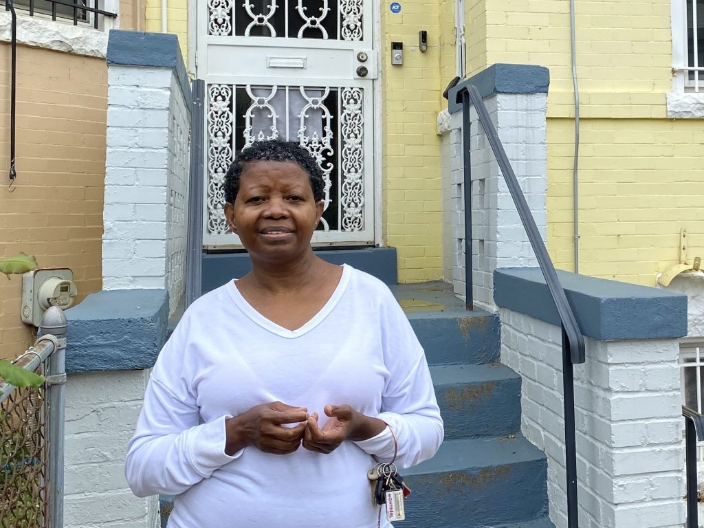 Katherine Gaines stands in front of her childhood home in Washington, D.C. She moved back in two years ago to help care for her mother, who has Alzheimer’s disease. Katherine Gaines stands in front of her childhood home in Washington, D.C. She moved back in two years ago to help care for her mother, who has Alzheimer's disease. (Andrea Hsu/NPR)