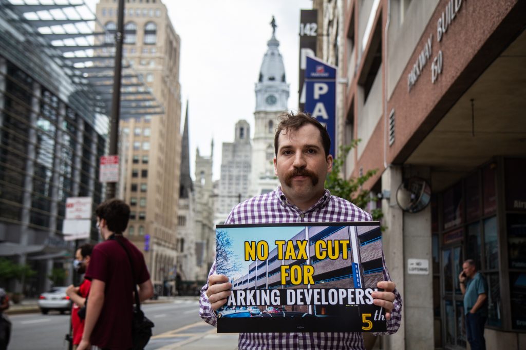 philly_parking_tax_protest_01_KP_061421 Daniel Trubman holds up a sign that says,