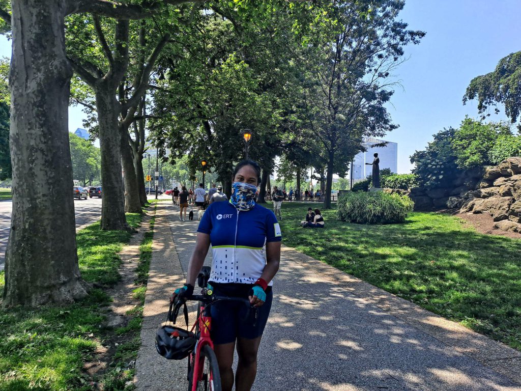 philly_summer_pandemic_XC_060621_02 Jessica Perry stands with her bike while wearing a face mask