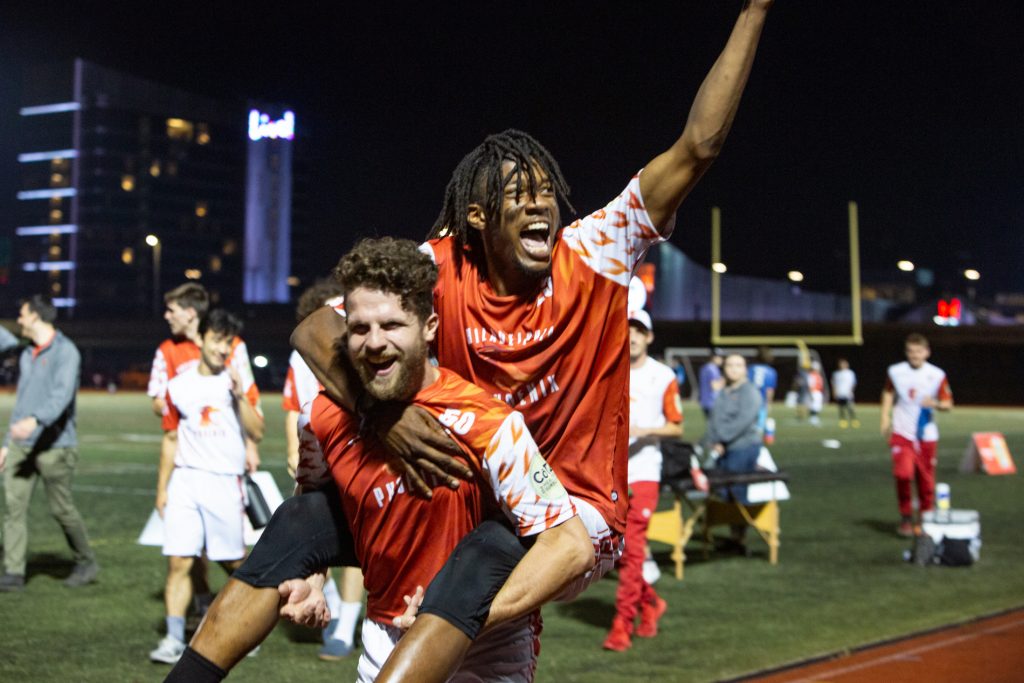 phoenix-ultimatefrisbee-supersite-02 Veteran Phoenix Eric Witmer picks up newbie Phoenix player Nate Little in celebration after their 21-16 win over the Tampa Bay Cannons at the South Philadelphia SuperSite, June 4th 2021. (Emily Cohen for Billy Penn)