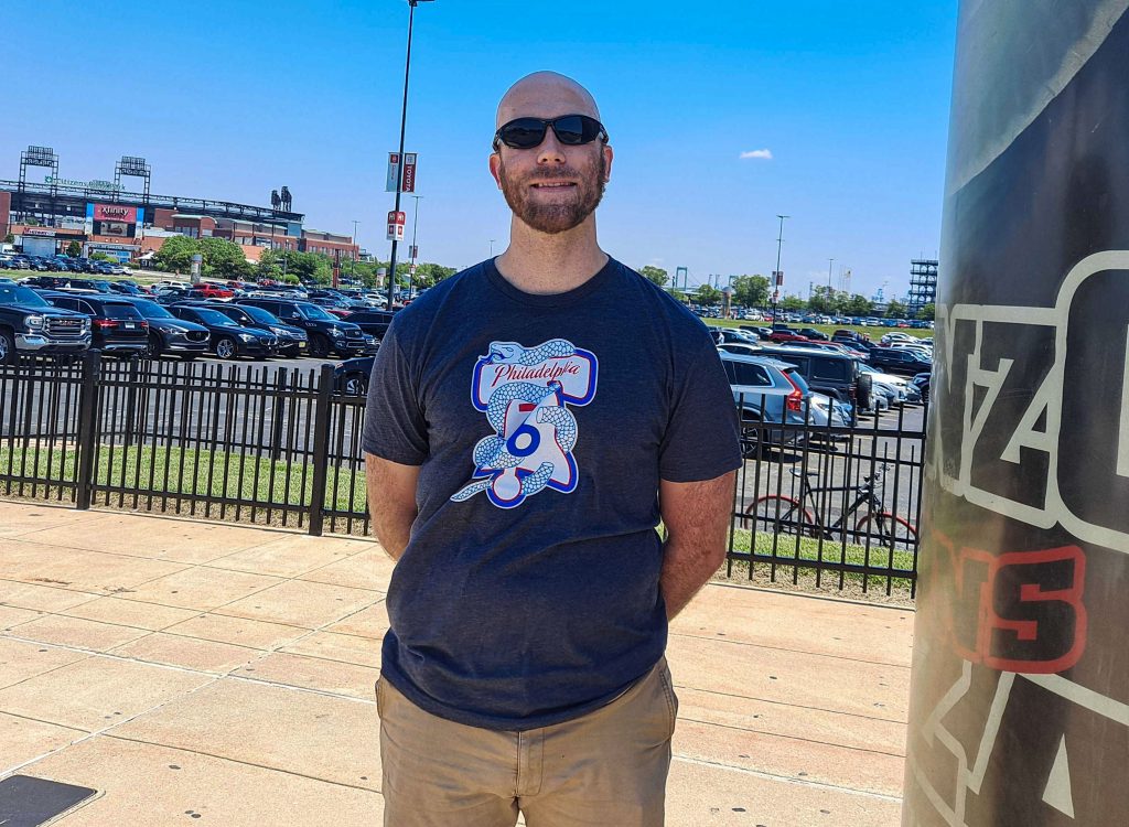 Luke Warne stands with his hands behind his back
