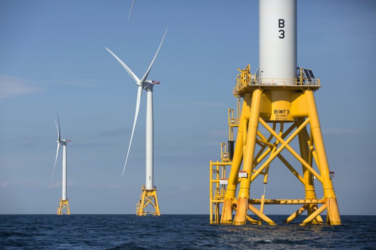 Three of Deepwater Wind's five turbines stand in the water off Block Island