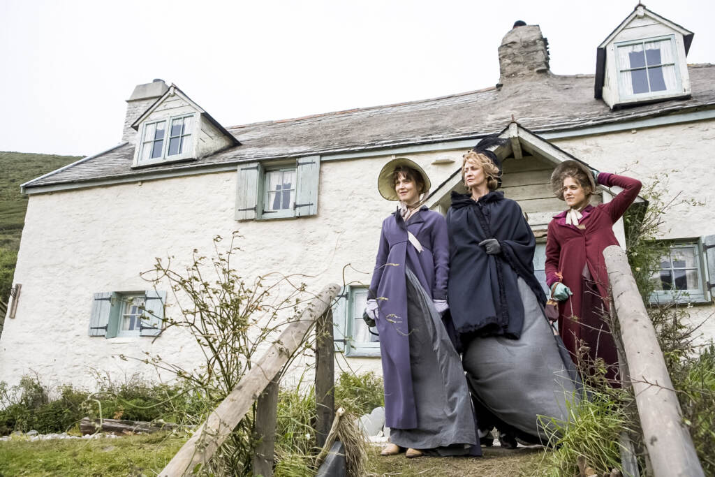 Hattie Morahan (as Elinor Dashwood), Charity Wakefield (as Marianne Dashwood), and and Hanet McTeer as Mrs. Dashwood standing outside their house in Sense and Sensibility