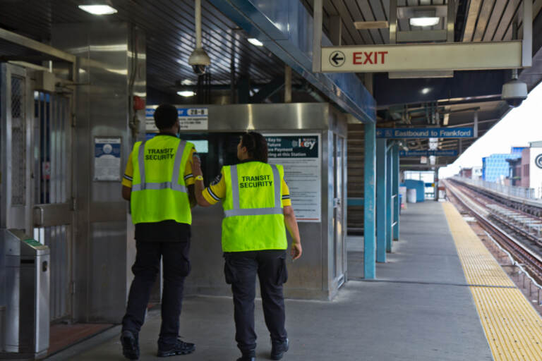 Transit security officers work on the platform of the Girard stop