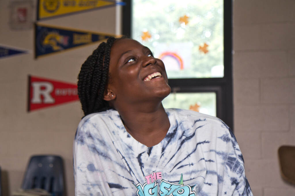 Monyria Harvey smiles while looking upward