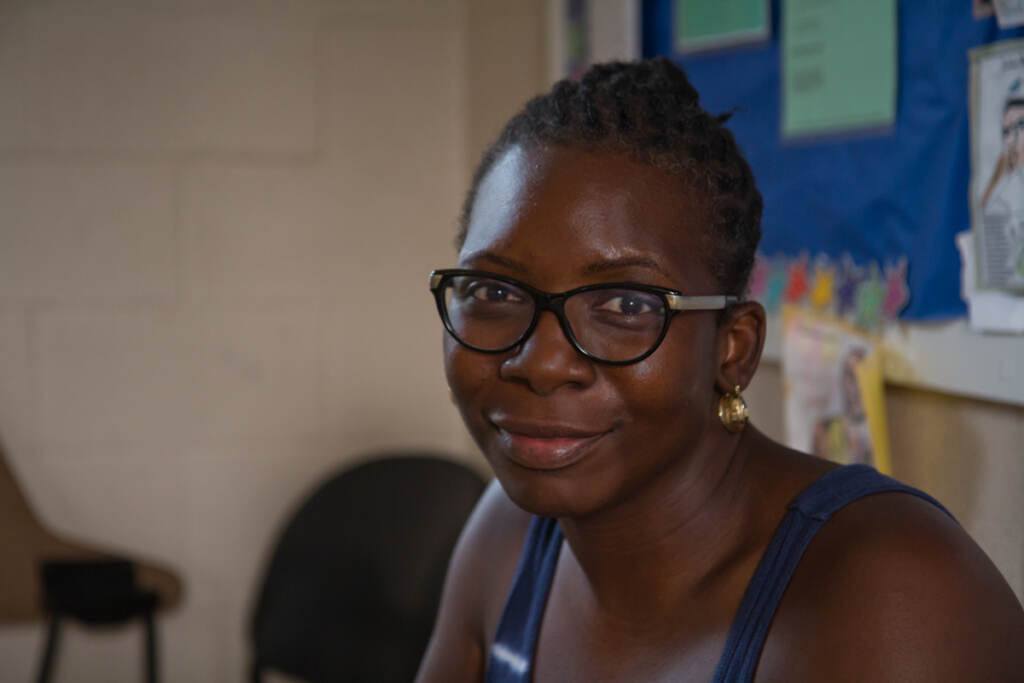 Joy Crudup-Dorsey smiles inside a classroom