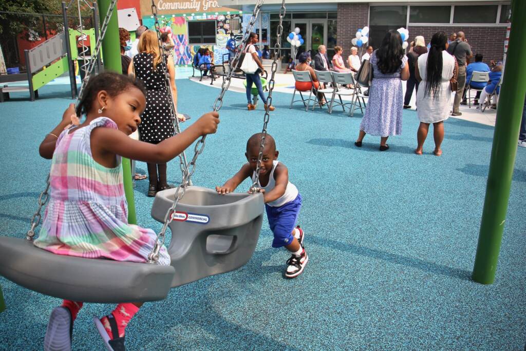 Children play on the swings at 8th and Diamond Playground
