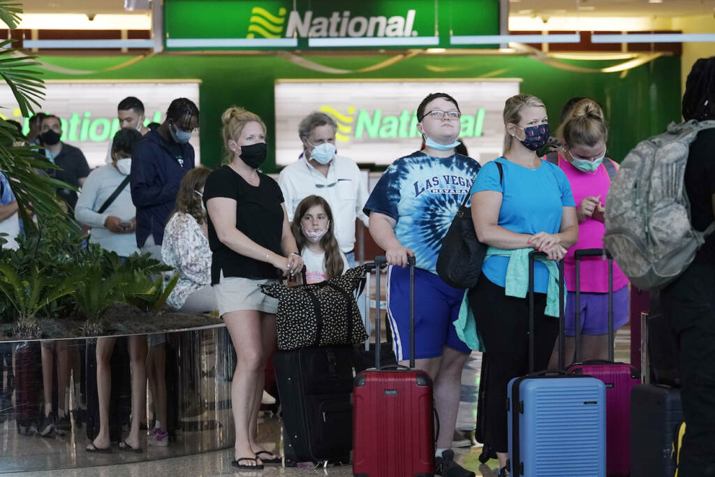 Memorial Day Florida People wait in line to rent vehicles at Miami International Airport