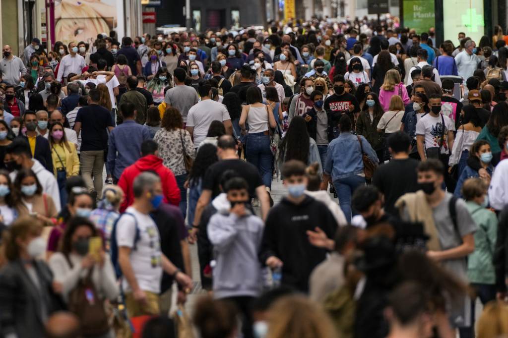Virus Outbreak Europe FILE - In this June 5, 2021, file photo, people wearing face masks to protect against the spread of coronavirus, walk along a commercial street in downtown Madrid, Spain. Countries across Europe are scrambling to accelerate coronavirus vaccinations to outpace the spread of the delta variant in a high-stakes race to prevent hospital wards from filling up again with patients fighting for their lives. (AP Photo/Manu Fernandez, File)