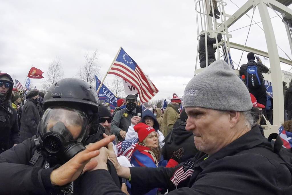 Capitol Breach Photographer Assaulted In this Jan. 6, 2021, image from video, Alan William Byerly, right, is seen allegedly attacking an Associated Press photographer during a riot at the U.S. Capitol in Washington. Byerly has been arrested on charges that he assaulted an Associated Press photographer and police officers. (AP Photo/Julio Cortez)
