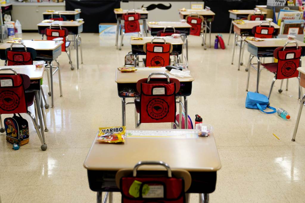 Virus Outbreak School Guidance Desks are spaced apart in a classroom