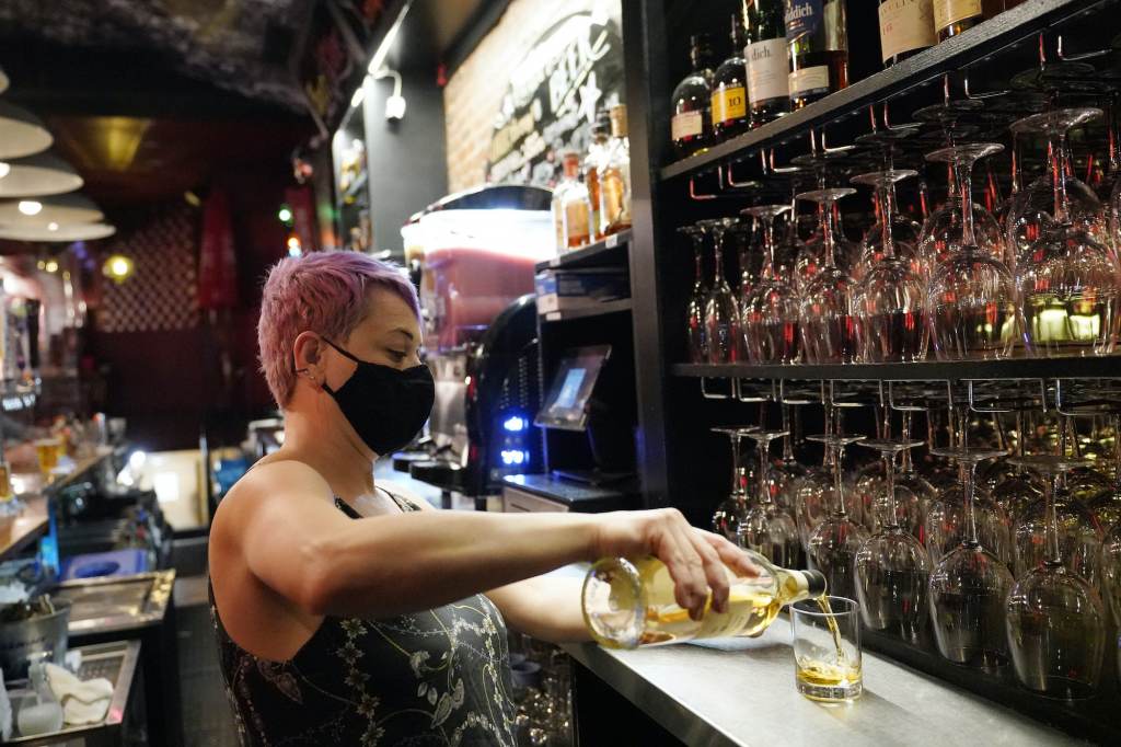Erin Bellard Erin Bellard pours a drink for a customer at her bar