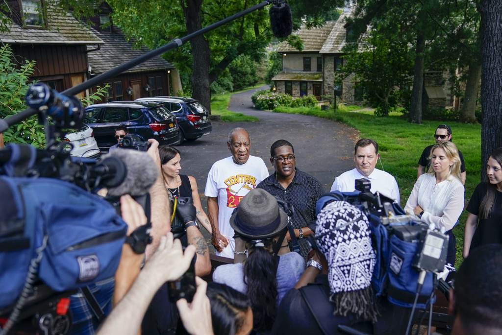 Bill Cosby Bill Cosby, center, and spokesperson Andrew Wyatt, right, approach members of the media
